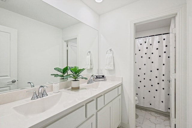 bathroom with curtained shower, vanity, and toilet