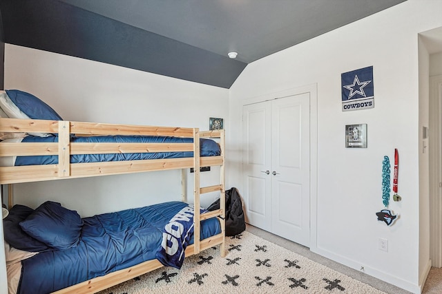 bedroom with carpet and lofted ceiling