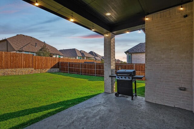 yard at dusk with a patio