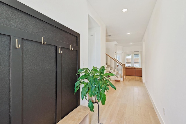 corridor with light hardwood / wood-style flooring