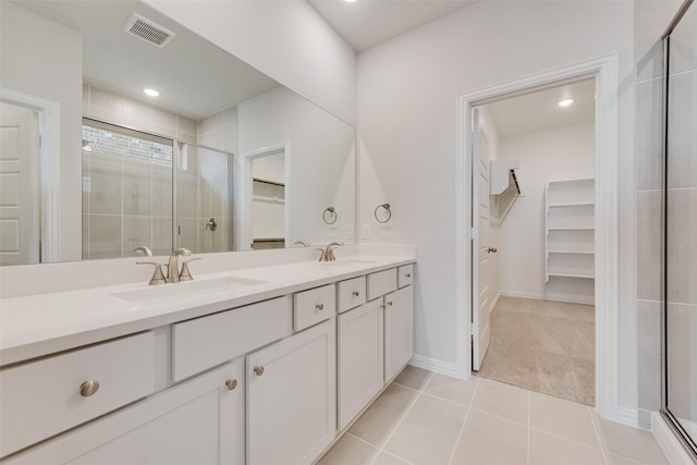 bathroom featuring vanity, tile patterned floors, and walk in shower