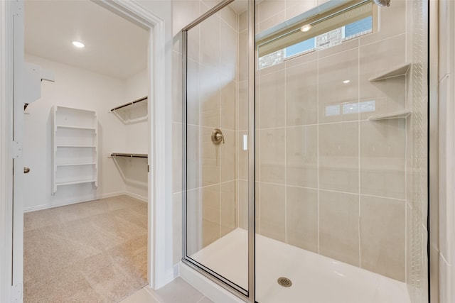 bathroom featuring a shower with shower door