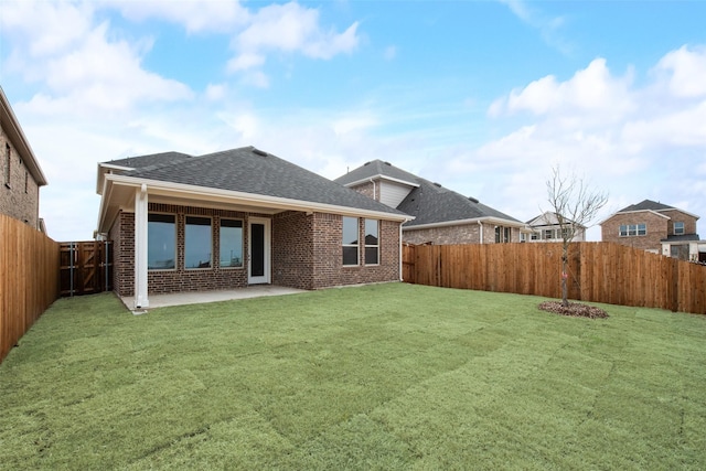 back of house featuring a yard and a patio