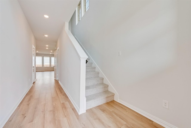 staircase with hardwood / wood-style flooring