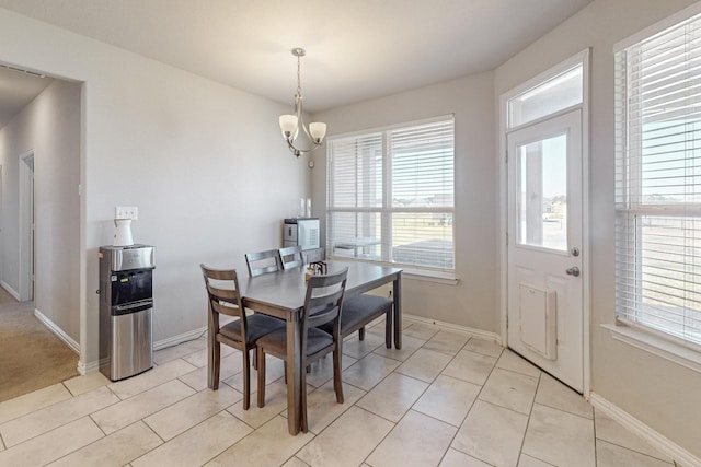 dining room with light tile patterned flooring and a notable chandelier