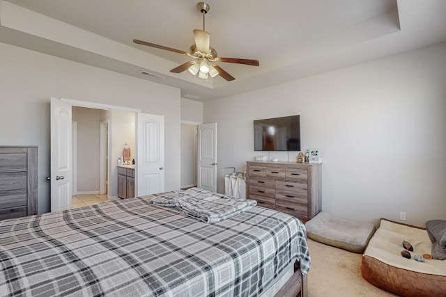 bedroom with a raised ceiling and ceiling fan