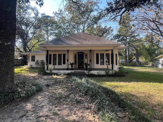 view of front of house with a front yard and covered porch