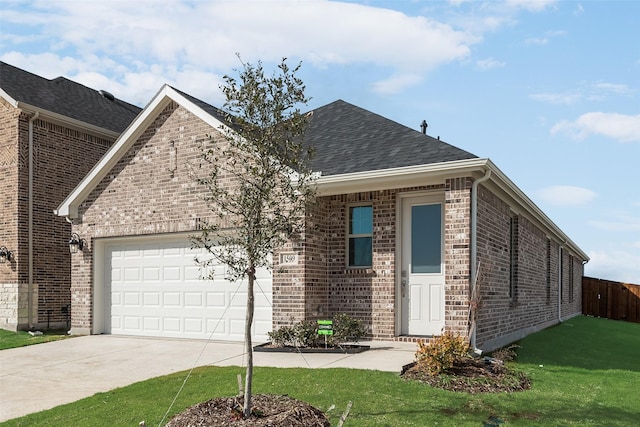 view of front of home featuring a garage and a front lawn