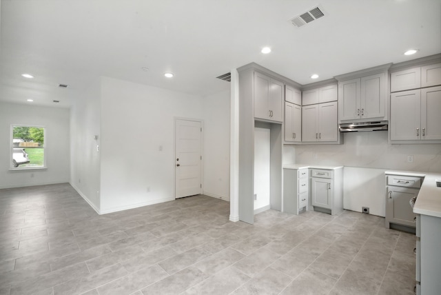 kitchen with gray cabinetry and light tile patterned floors