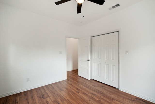 unfurnished bedroom featuring a closet, ceiling fan, and dark hardwood / wood-style flooring