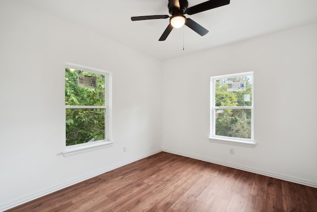 empty room featuring ceiling fan and hardwood / wood-style floors