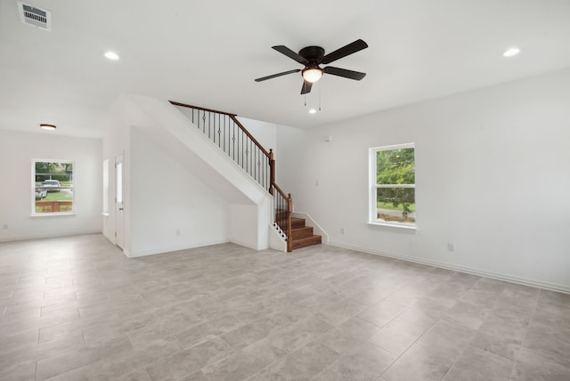 unfurnished living room featuring ceiling fan