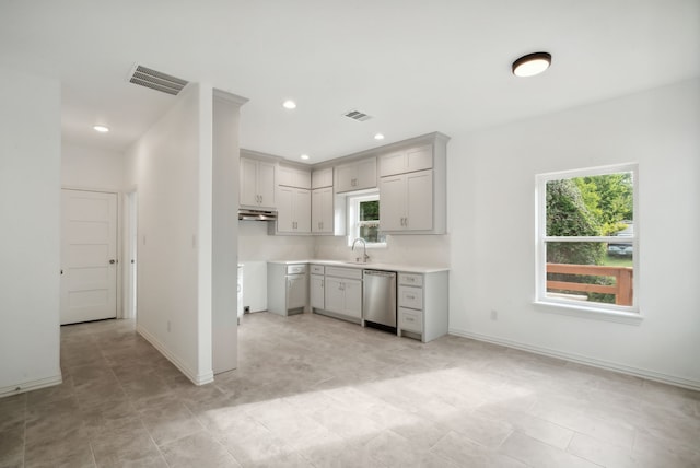 kitchen with light tile patterned flooring, sink, and stainless steel dishwasher