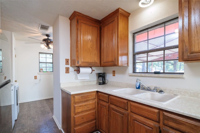 kitchen with dark wood-type flooring, ceiling fan, a textured ceiling, and sink