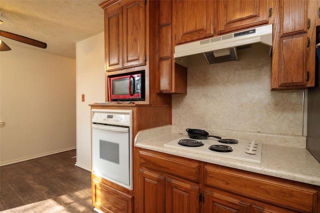 kitchen with dark hardwood / wood-style floors, ceiling fan, a textured ceiling, and white appliances