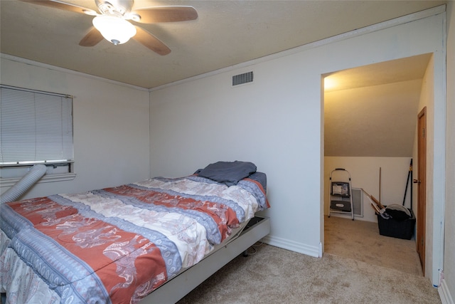 bedroom featuring light colored carpet, vaulted ceiling, and ceiling fan