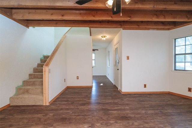 spare room with ceiling fan, beamed ceiling, and dark hardwood / wood-style flooring