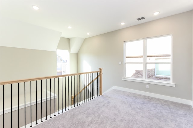 hall featuring lofted ceiling and carpet floors