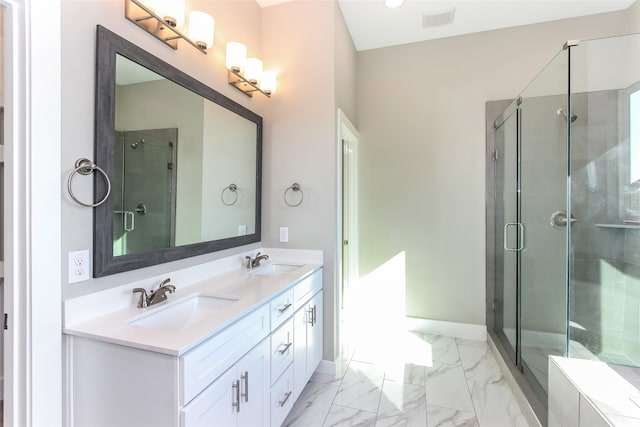 bathroom with vanity and a shower with shower door