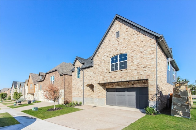 view of front of home with a front yard and a garage