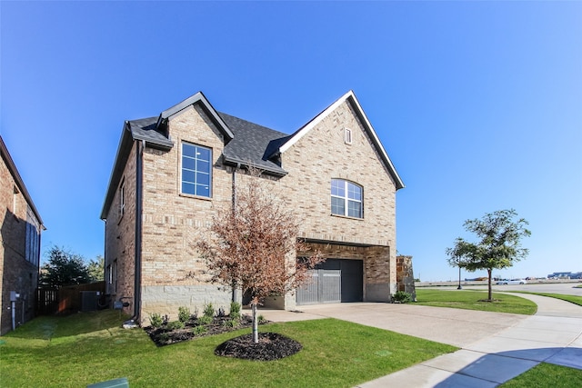 view of front of property with a front yard, a garage, and central air condition unit