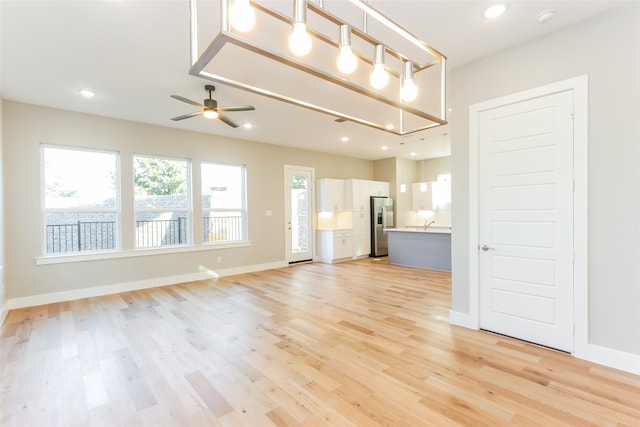 unfurnished living room featuring light hardwood / wood-style floors and ceiling fan