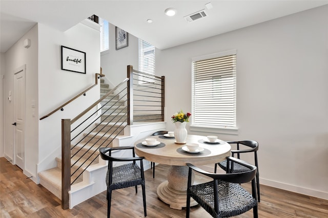 dining area featuring a wealth of natural light and hardwood / wood-style flooring