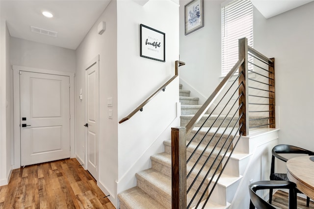 stairs with hardwood / wood-style flooring