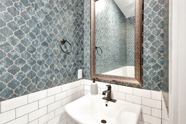 bathroom with tile walls and sink