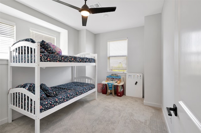 bedroom with ceiling fan and light colored carpet