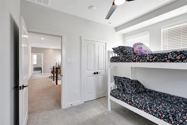 carpeted bedroom featuring a closet and ceiling fan