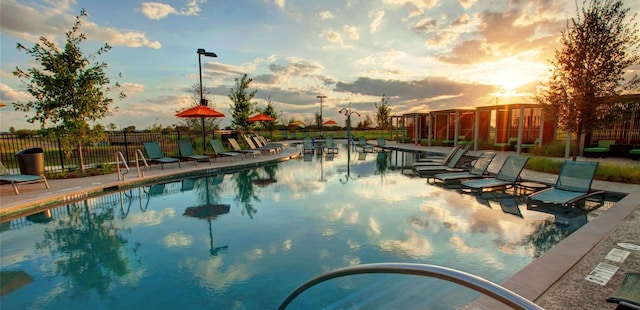 view of pool at dusk