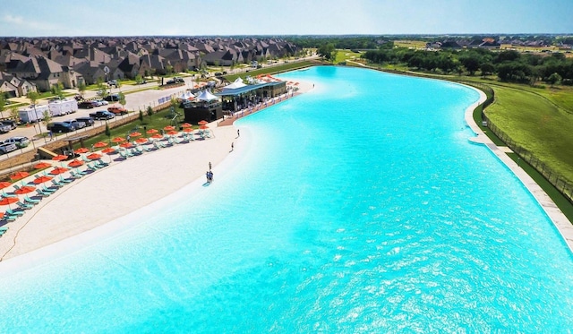 view of pool featuring a view of the beach and a water view