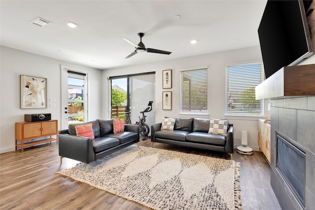 living room featuring hardwood / wood-style flooring and ceiling fan