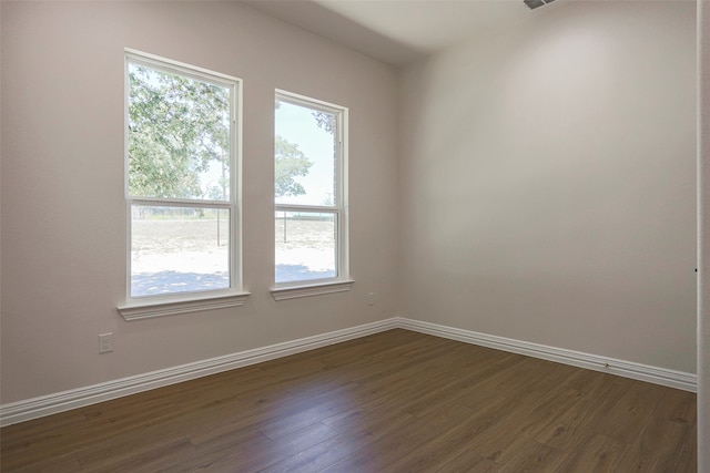 spare room featuring dark hardwood / wood-style floors