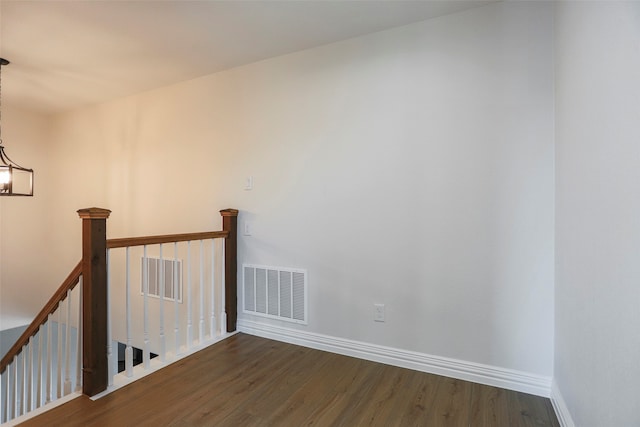 interior space featuring a notable chandelier and dark hardwood / wood-style flooring