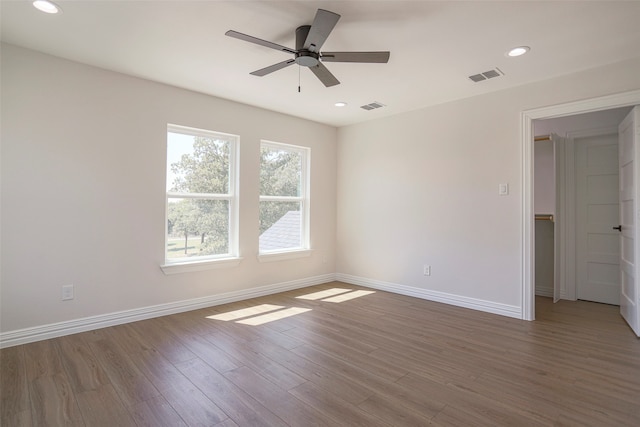 empty room with wood-type flooring and ceiling fan