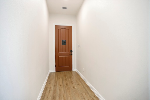 hall with light wood-type flooring