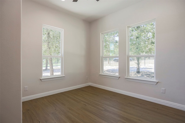 unfurnished room featuring dark hardwood / wood-style floors and ceiling fan