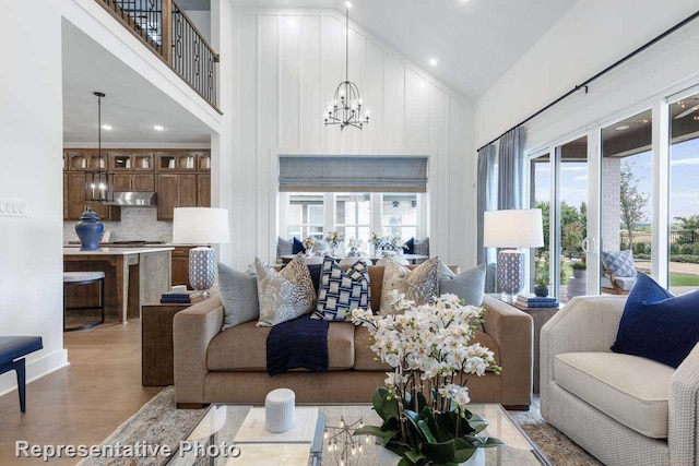 living room featuring high vaulted ceiling and a chandelier