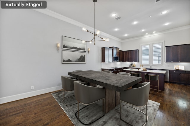 kitchen with dark hardwood / wood-style flooring, a kitchen island, a kitchen bar, crown molding, and dark brown cabinetry