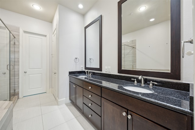 bathroom with vanity, walk in shower, and tile patterned flooring