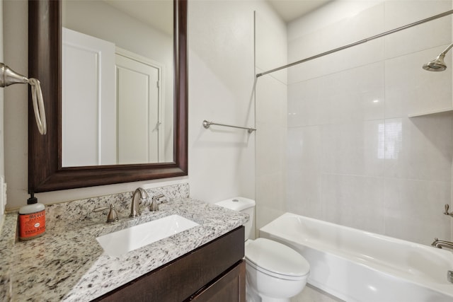 full bathroom with toilet, tiled shower / bath combo, and vanity