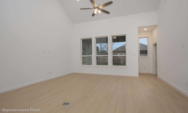 2414 Plumeria Ln, Celina, TX 75009 - empty room with high vaulted ceiling, a ceiling fan, light wood-style floors, and baseboards