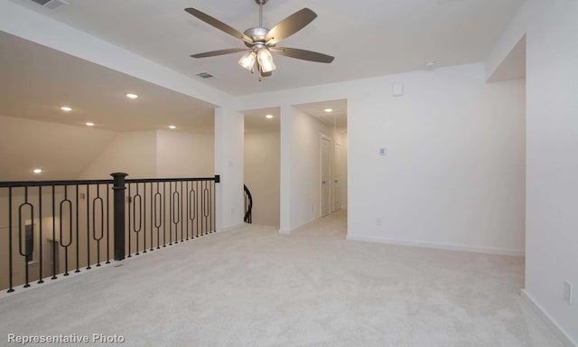 unfurnished room featuring ceiling fan and light colored carpet