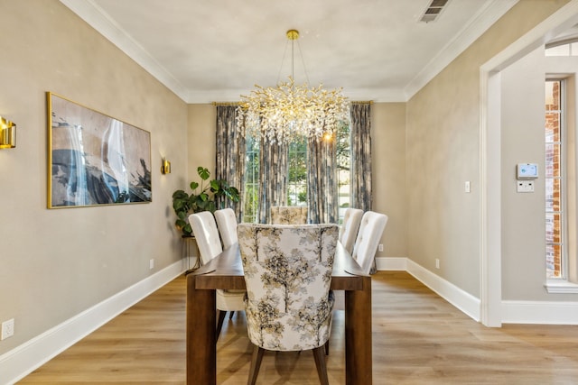 dining area with crown molding, hardwood / wood-style flooring, and a chandelier