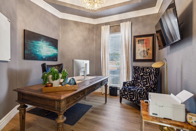 office area with crown molding, hardwood / wood-style floors, a chandelier, and a raised ceiling