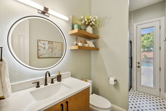 bathroom with vanity and toilet