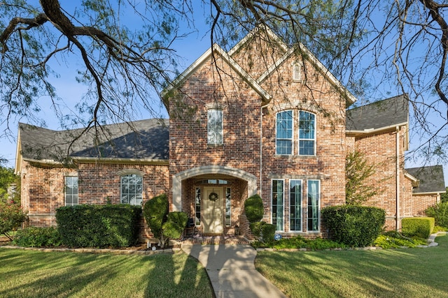 view of front of house featuring a front yard and french doors