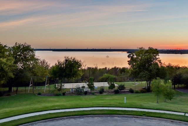 view of property's community featuring a yard and a water view